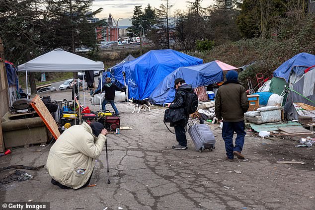 The Supreme Court ruled Friday that cities can ban homeless people sleeping outdoors, even in areas of the West Coast where shelter is lacking.  Residents of a homeless camp are seen in Seattle in March