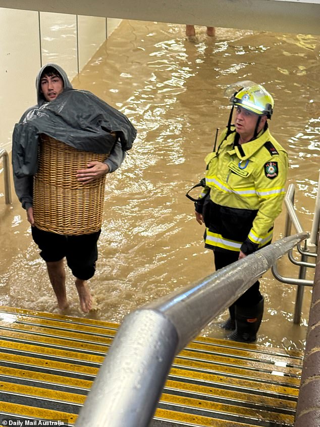 Commuters were seen walking out of the station barefoot with baskets full of clothes as the fire brigade was called to the scene.