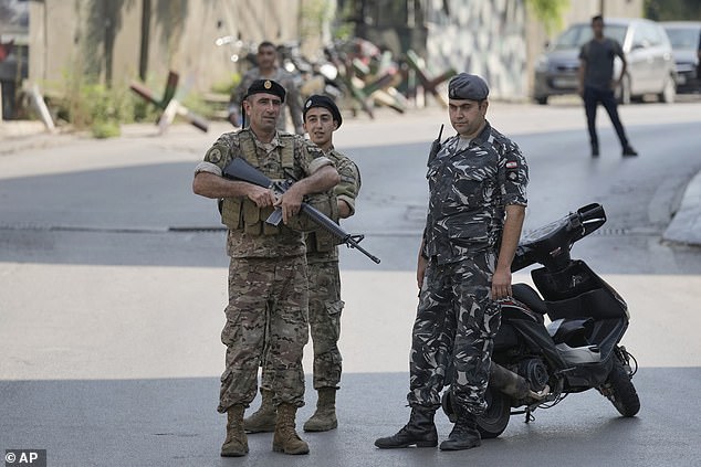 Lebanese security forces stand guard on Wednesday on a road leading to the US embassy in Aukar, a northern suburb of Beirut, Lebanon