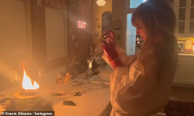 Taylor Swift was filmed brandishing a fire extinguisher in a new video of herself putting out a fire in her New York City apartment – ​​shared by collaborator Gracie Abrams
