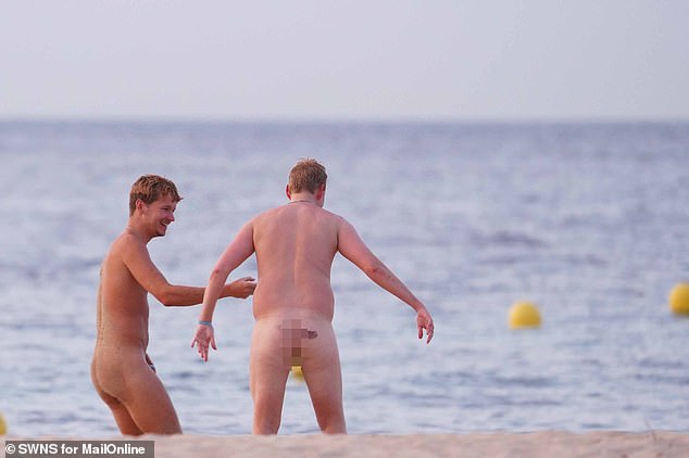 Drinkers hit the beach as the clubs close and the sun rises, then head into the sea to cool off in Magaluf, Mallorca