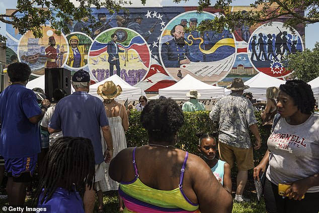People gather to celebrate the opening of the mural as part of the Juneteenth Legacy Project commemorating the end of slavery in the United States on June 19 in Galveston, Texas