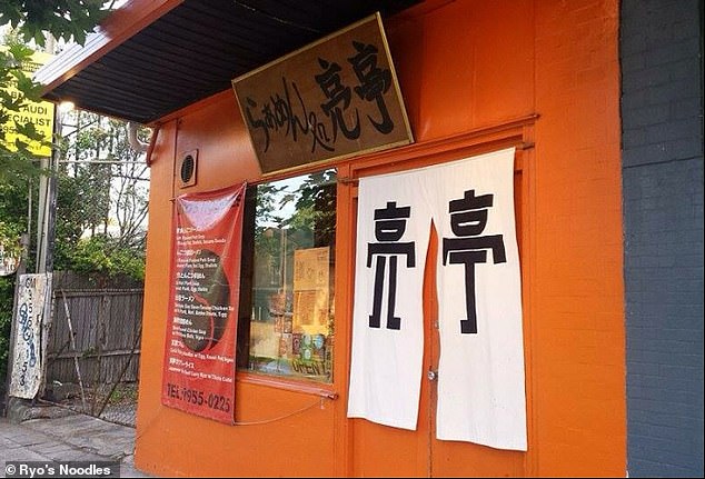 An old curtain hanging over a doorway marks the entrance to one of the 'best ramen restaurants in Australia' - and it's been around for 21 years