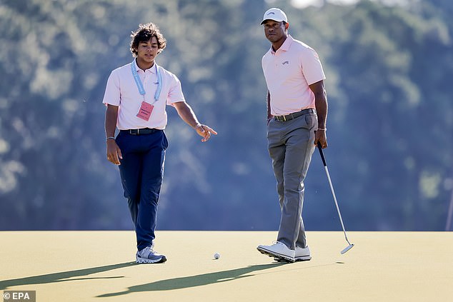 Charlie Woods, 15, gives his legendary father Tiger some advice Tuesday in Pinehurst