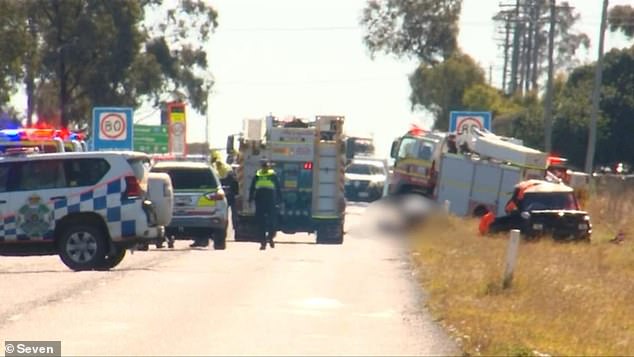 A ute and a sedan collided northwest of Toowoomba in Queensland's Western Downs region at about 10.50am on Monday (emergency services are pictured at the scene).