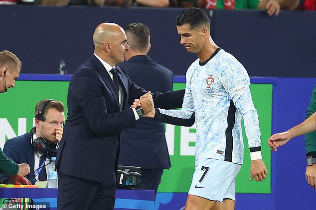 The task for Roberto Martinez (left) is to calm Cristiano Ronaldo down and get the best out of him