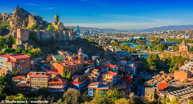 Solo travel expert Helen Youngman recommends Georgia's capital Tbilisi (above) for a getaway for one.  According to her, the 'hospitable locals' are one of the many advantages