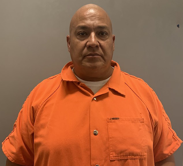 Former school police chief Uvalde Pedro 'Pete' Arredondo pictured in an orange jumpsuit after being charged for their botched response to a school massacre on May 24, 2022