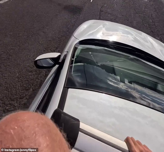 The man was filmed jumping from the roof of a moving car (pictured) and landing in the water 13 meters below the Currumbin Creek Bridge.