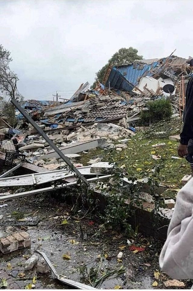 Rescuers have stepped up the desperate search for a woman who feared being trapped under a pile of rubble after a mansion was destroyed by an explosion (pictured)