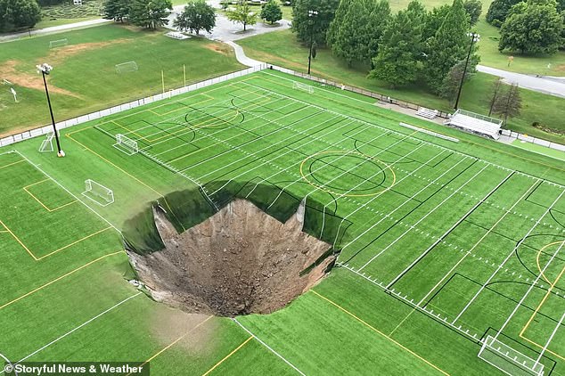 The massive sinkhole suddenly appeared Wednesday morning in Gordon Moore Park in Alton, Illinois - though thankfully no injuries were reported