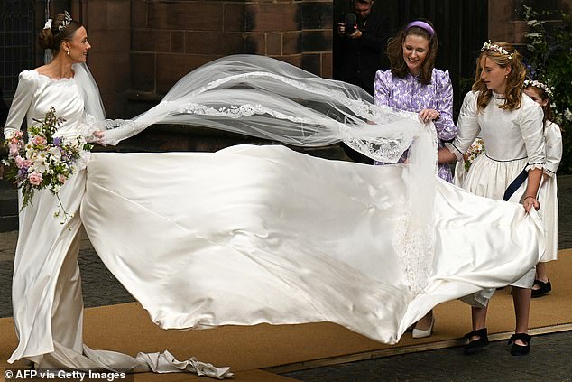 A dramatic spectacle is created by a gust of wind at the wedding of Olivia Henson and the Duke of Westminster at Chester Cathedral in June