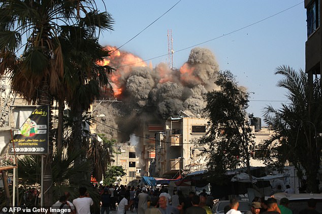 A ball of fire and black smoke rises shortly after an Israeli airstrike on a residential building in the town of Bureij in the central Gaza Strip on June 3, 2024