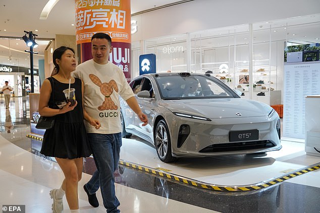 Chinese electric carmakers are expected to flood Australia with cheap imports as the Americans and Europeans raise tariffs to protect their local automakers (pictured is a NIO ETS EV in Beijing)