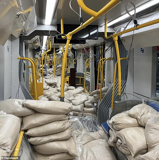 It may seem like a sandbag-laden train carriage in Sydney (pictured) was destroyed before it even had a chance to enter service - but there's a very innocent explanation