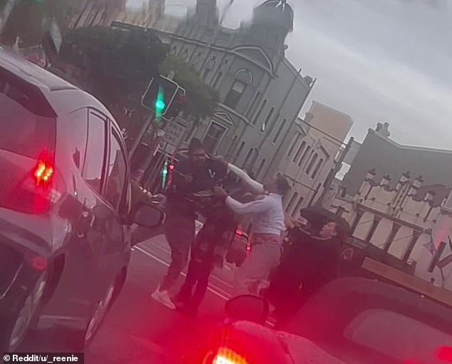 Wild footage captured the moment a brawl took place on a busy street in a trendy suburb
