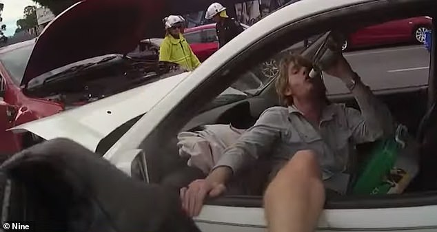 Previously unreleased footage shows driver Curtis Owen guzzling wine behind the wheel, minutes after causing a crash on a major Queensland road
