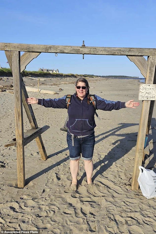 This photo of Patrick Acord shows his wife, Jamie Acord, at Popham Beach, in Phippsburg, Maine, where she sank hip-deep in quicksand, Saturday, June 1, 2024