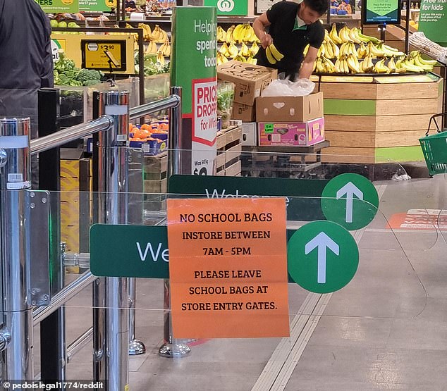 Shoppers are outraged by a sign (pictured) placed at the gate of a Woolworths store telling schoolchildren to leave their bags outside