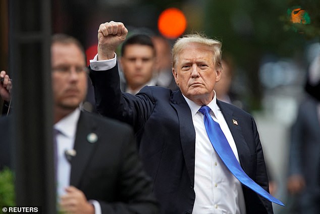 Former US President Trump clenches his fist as he returns to Trump Tower after May's verdict