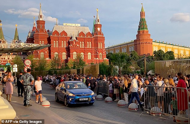 Fans wait for Kanye West at the Four Seasons Hotel in central Moscow, where the American rapper is believed to be staying