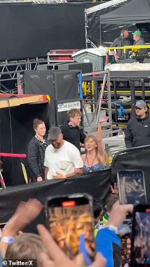 Taylor waves to the audience as she and Travis walk off the stage in Dublin arm in arm