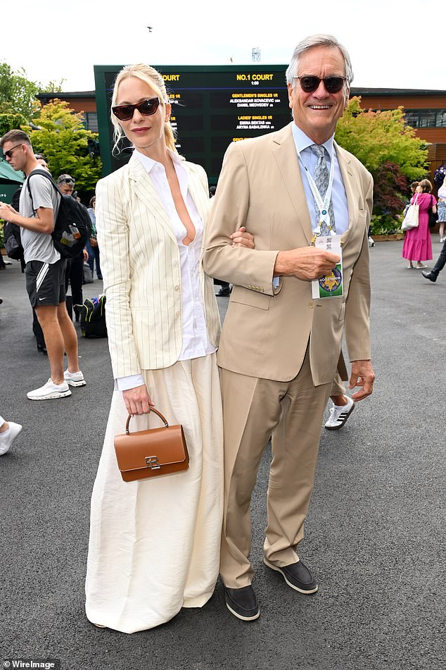 Poppy Delevingne looked effortlessly chic in an off-white suit as she attended a celebrity-packed event with her father Charles