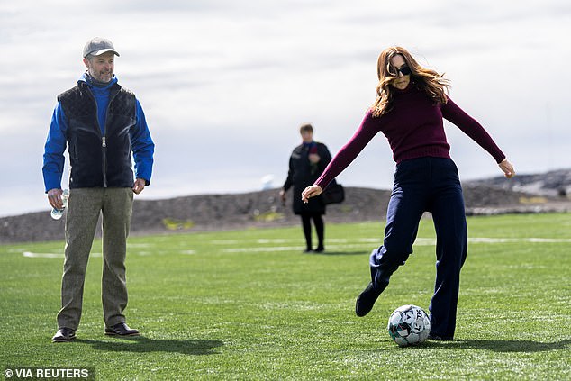 The Australian-born Queen, 52, showed her sporty side during the trip to Greenland, playing football