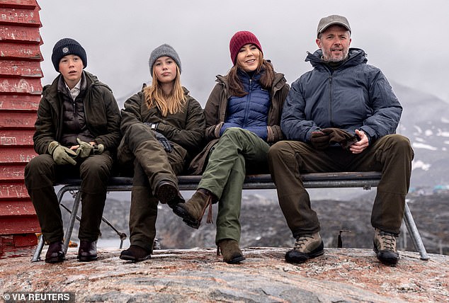The family posed for a photo while visiting a whale microphone lookout in Qeqertarsuaq