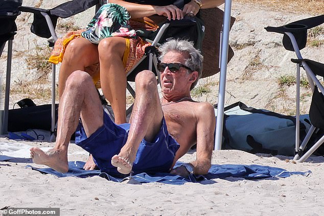 Later he traded his comfortable beach chair and went sunbathing on a towel on the sand