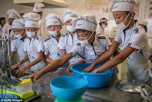 Children participate in a cooking class at Songdowon International School Children's Camp on August 22, 2018 in Wonsan, North Korea