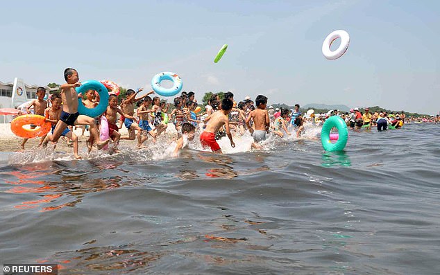 Schoolchildren play in the water at the Songdowon International Children's Camp in the city of Wonsan, North Korea, in this undated photo released by the Korean News Agency