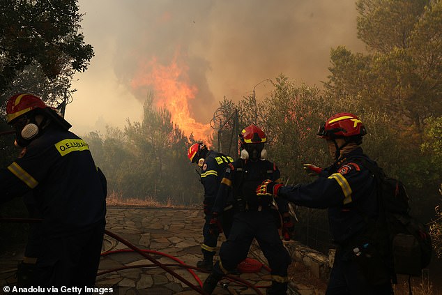 STAMATA -- Firefighters battle flames in region near Greek capital