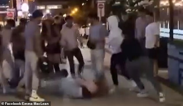 Video shows the group of about seven to 10 men kicking one of the women, who lies on the ground surrounded by her attackers, while the other tries to break free from the grip of another man.