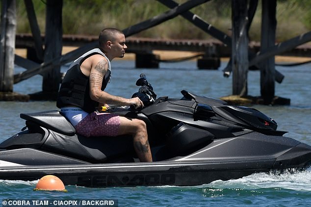 Romeo was spotted taking a ride on a jet ski wearing a purple patterned swim short