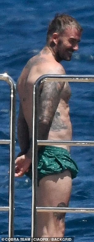 David's massive tattoo collection was on display as he pulled up his swimming trunks to work on his tan