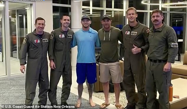 Barlow is pictured with the Coast Guard officers who saved his life