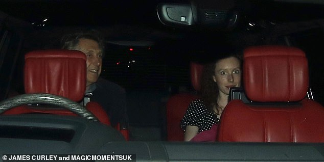 The couple were seen giggling together in the backseat of his car