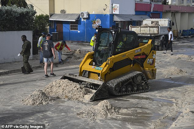 Current models predict the 165 mph superstorm will head toward Mexico's Yucatan Peninsula on Thursday night. Pictured: Sand is cleared from the southern coast of Barbados on Monday, July 1