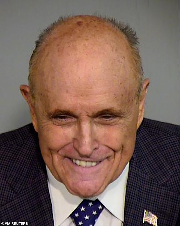 Giuliani poses for a booking photo from the Maricopa County Sheriff's Office, where he posted $10,000 bail while facing charges of conspiring to falsely claim Arizona's electoral votes for Trump