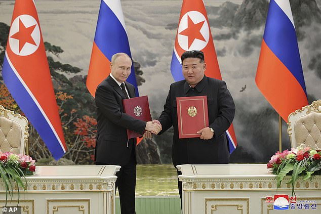 Kim Jong Un, right, and Russian President Vladimir Putin shake hands after signing a comprehensive strategic partnership in Pyongyang, North Korea Wednesday, June 19, 2024