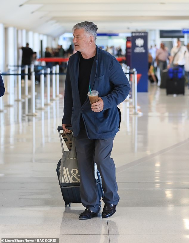 The actor wore a black top and a gray suit as he was spotted arriving at LAX before meeting DelPiano