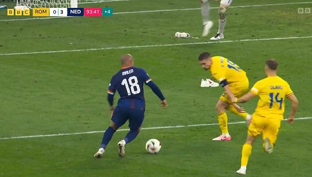 The boots were placed dangerously in the Romanian penalty area when Donyell Malen cut inside