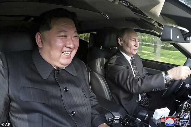 In this photo provided by the North Korean government, Russian President Vladimir Putin (right) rides in a car with North Korean leader Kim Jong Un in the front passenger seat in North Korea on June 19, 2024.