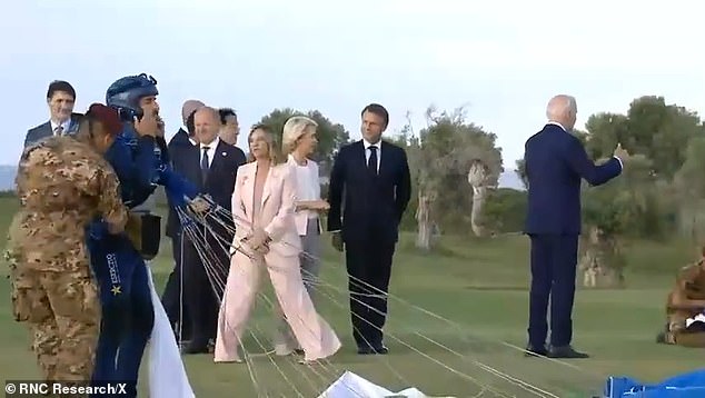 Biden appeared to walk away from other world leaders at the G7 summit last month (pictured). The White House has maintained that he waved to paratroopers who were pictured off-camera, but his movements were still unusual
