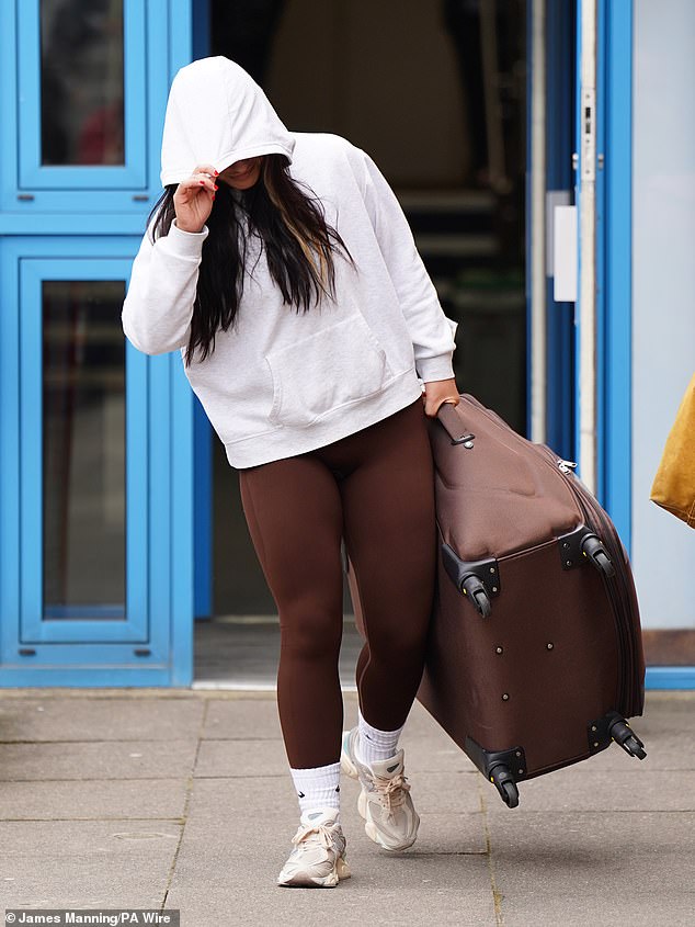 Linda De Sousa Abreu was seen carrying a large suitcase and hiding her face as she left Uxbridge Crown Court on Monday.