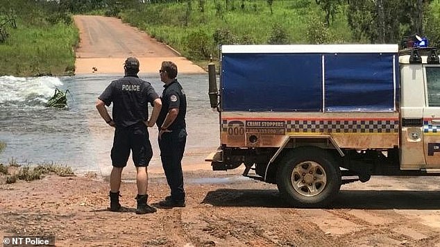 Police have launched an urgent search on land and in the water for the child. (Pictured: Police at the Moyle River crossing between Peppimenarti and Palumpa)
