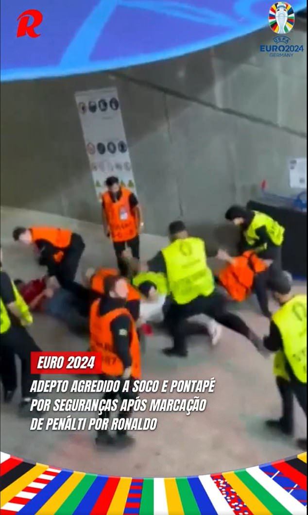 Once on the ground, stewards were seen kicking the fan while another was being held down