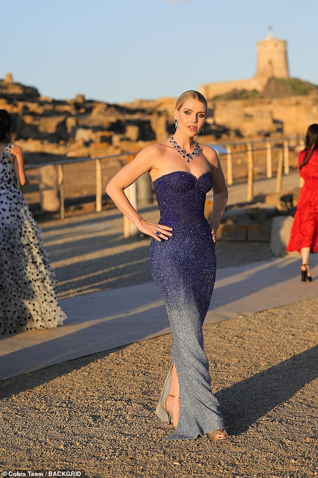Kitty Spencer was photographed posing with her hands on her hips, wearing an embellished blue strapless dress while standing in the sun