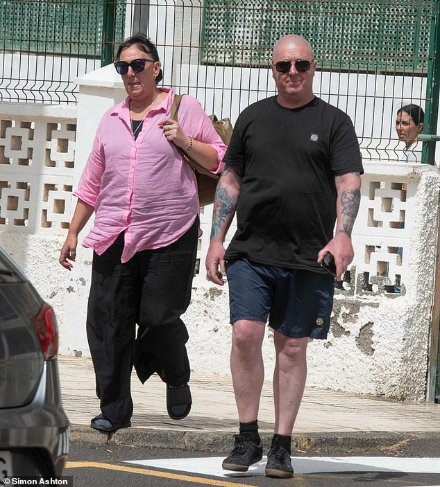 Debbie pictured with Jay's father Warren Slater as she leaves the Guardia Civil in Playa de las Americas